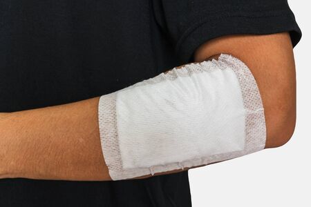 Left arm of a male has been injured on white backgroundの写真素材