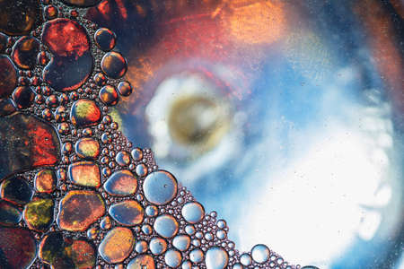 Close up oil floating on water  surface used as backgroundsの写真素材