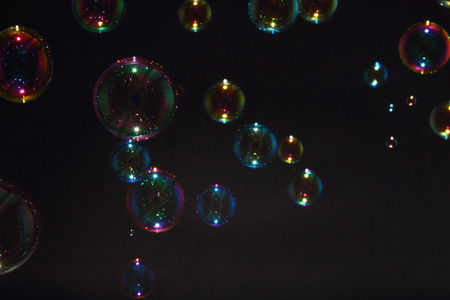 Blurred colorful air bubbles from the soap bubbles on background.の写真素材