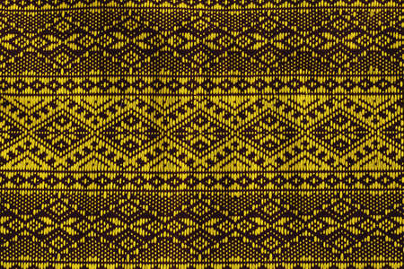 Thai fabric texture background with yellow pattern beautifulの写真素材