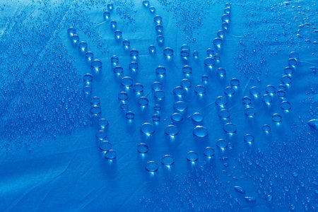 Water droplets on blue fiber waterproof fabricの写真素材