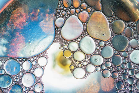 Close up oil floating on water  surface used as backgroundsの写真素材