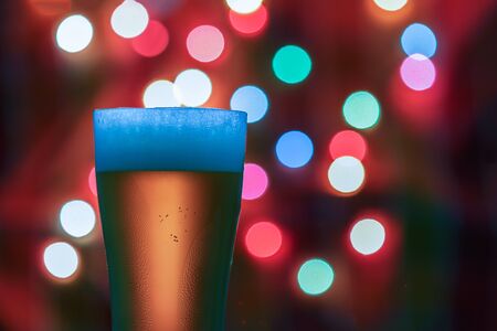 Glass of beer on the bokeh lights background .の写真素材