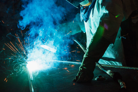 Welder of Metal Welding with sparks and smoke