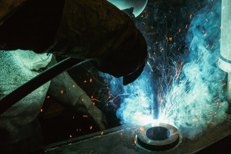 Welder of Metal Welding with sparks and smoke in steel industryの写真素材