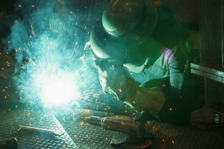 Welder of Metal Welding with sparks and smoke