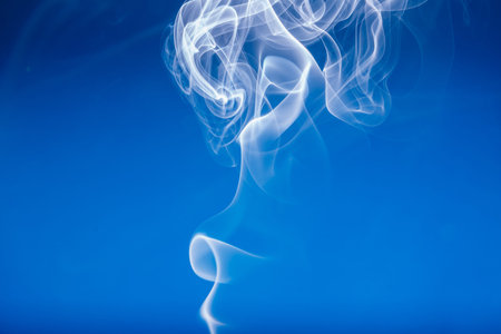 White smoke shape on a blue  backgroundsの写真素材