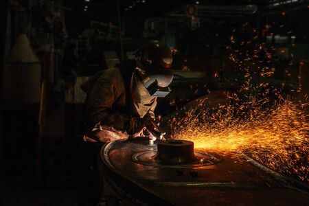 Welder arc Gouging carbon electrode rods   with sparks and smokeの写真素材