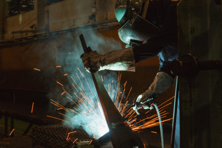 Welder of Metal Welding with sparks and smoke
