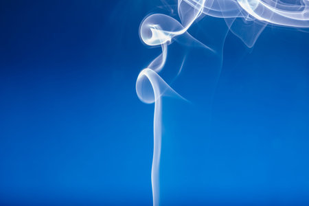 White smoke shape on a blue  backgroundsの写真素材