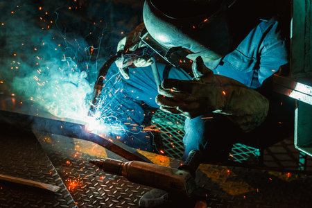 Welder of Metal Welding with sparks and smoke