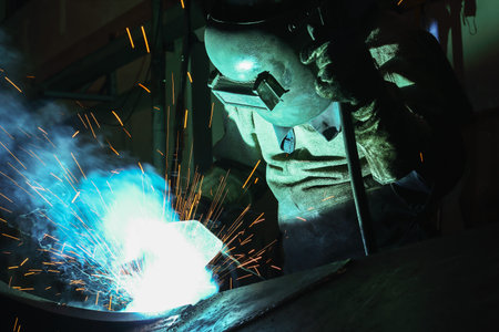 Welder of Metal Welding with sparks and smoke
