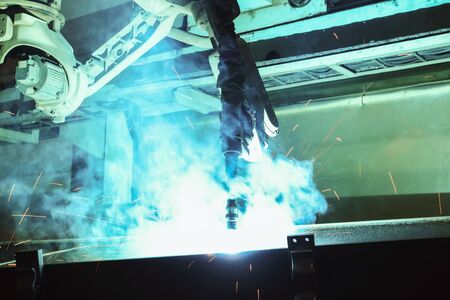 Robots used Metal Welding with sparks and smoke in manufacturingの写真素材