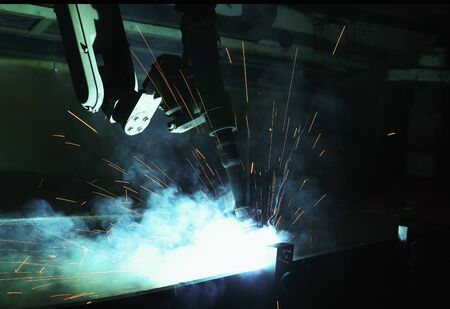 Robots used Metal Welding with sparks and smoke in manufacturingの写真素材