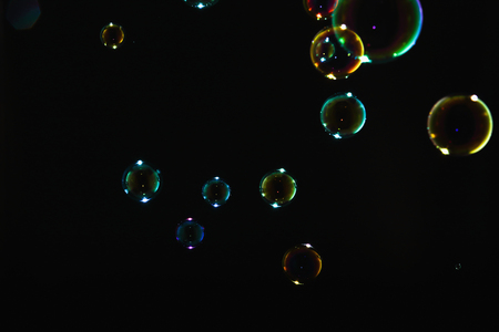 Rainbow soap bubbles on a black backgroundの写真素材