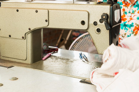 Industrial sewing machines with workers being sewn.