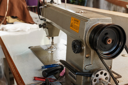 Industrial sewing machines close up , clothes at tailors shop.の写真素材