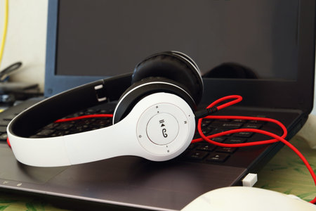 Headphones  white  put on  a notebook backgroundの写真素材
