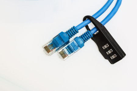 Two Network cable locked with a lock on white background