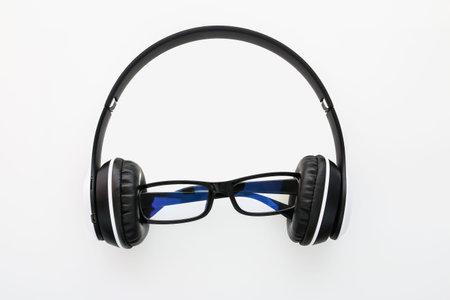 Headphones and glasses isolated on a white background