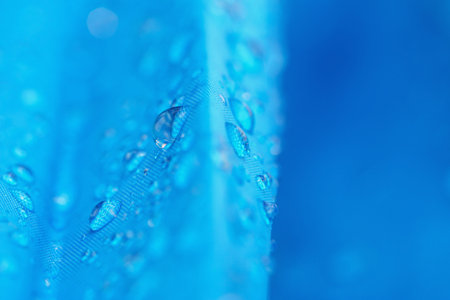 Water droplets on  blue waterproof fabricの写真素材