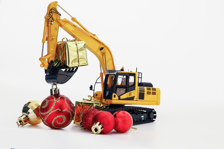 Christmas gift with  Excavator model ,  Holiday celebration concept new year on white backgroundの写真素材