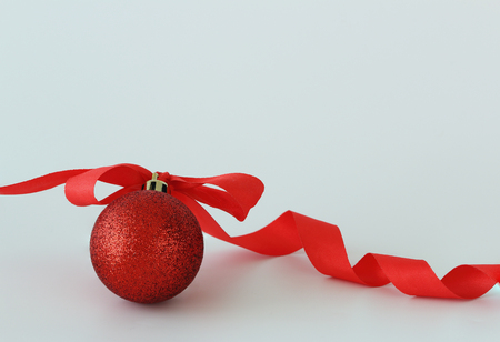 Christmas ornament with red ribbon on white background in  new year festiveの写真素材