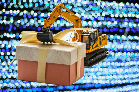 Gift box  with Excavator model , Holiday celebration concept new year on bokeh backgroundの写真素材