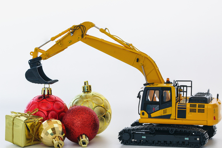 Christmas ornament and Excavator model ,  Holiday celebration concept new year on white backgroundの写真素材