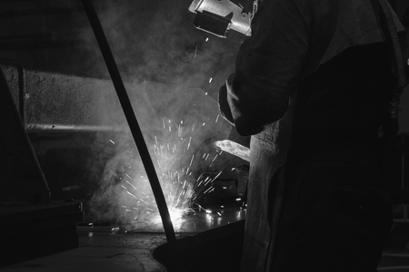Welder of Metal Welding with sparks and smoke in factoryの写真素材