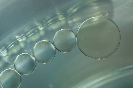 Close up oil drops floating on water surface  used as background