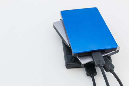 External disk hard drive connected to notebook for backup from computer data on white backgroundの写真素材