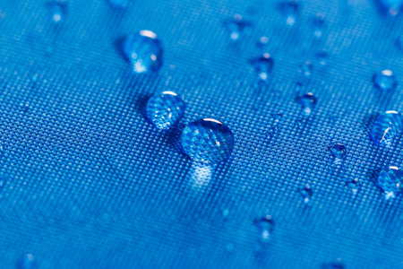 Rain water droplets on  blue waterproof fabric  backgroundの写真素材