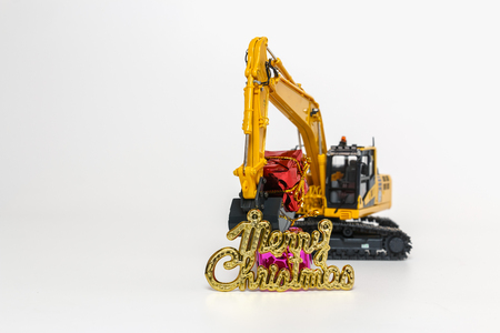 Christmas ornament and Excavator model ,  Holiday celebration concept new year on whiteの写真素材