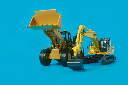 Excavator and Wheel loader model isolated on cyan  in industrial constructionの写真素材