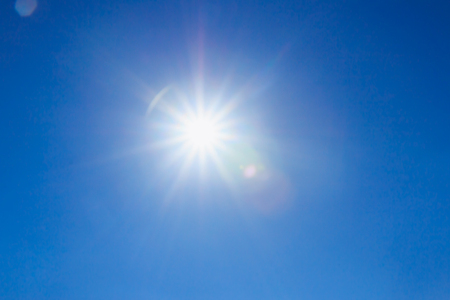 Shining sun at clear on blue sky  with a copy spaceの写真素材