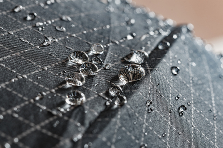 Rain Water droplets on a black waterproof fabric of the umbrellaの写真素材