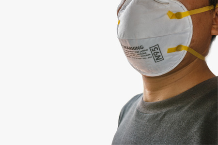 Man wearing facial  N95 Filter face mask,  Ecology, air pollution, Environmental ,dust and smoke welding protection with smallの写真素材