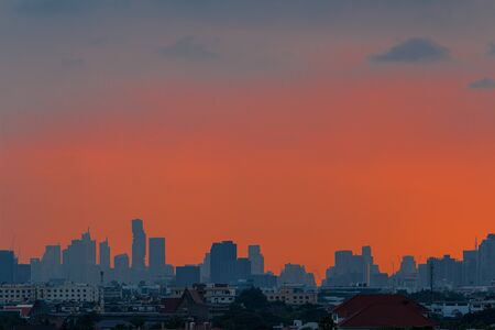 Orange  sky before sunset, At city scenery of Bangkok with Modern building silhouette (Thailand)の写真素材