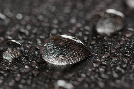Water droplets on a black waterproof fabric