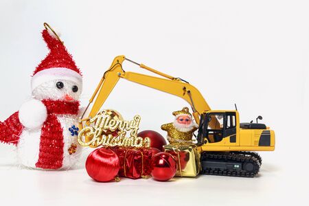 Christmas ornament with Excavator model ,  Holiday celebration concept new year on white backgroundの写真素材