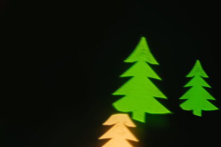Green lights shape  of Christmas tree on blackの写真素材