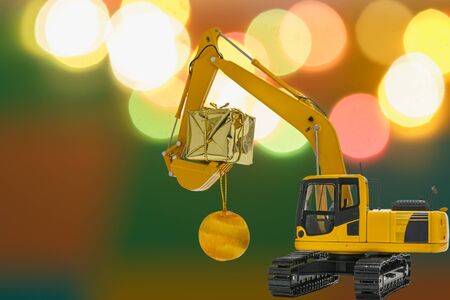 Christmas ornament and Excavator model , Holiday celebration concept new year on lights colorful backgroundの写真素材