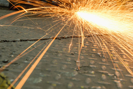 Grinding  sparks of tools on steel in factory with manufacturing