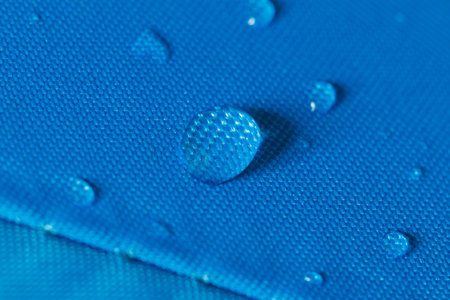 Water droplets on a  waterproof fabric blue background