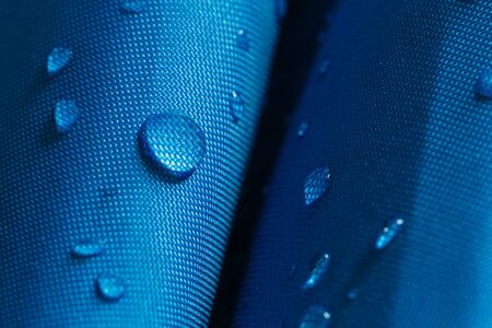 Water droplets on a  waterproof fabric  blueの写真素材