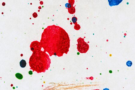 Ink drop color splash  on white paperの写真素材