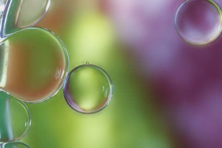 Close up oil drops floating on water surface