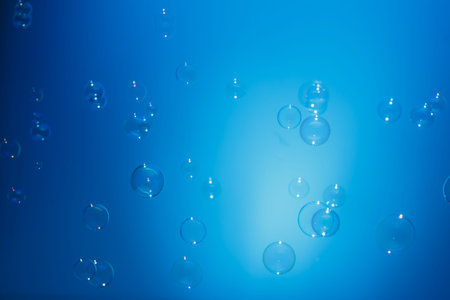 Soap bubbles in air with  float on blue