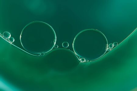 Close up oil drops floating on water surfaceの写真素材